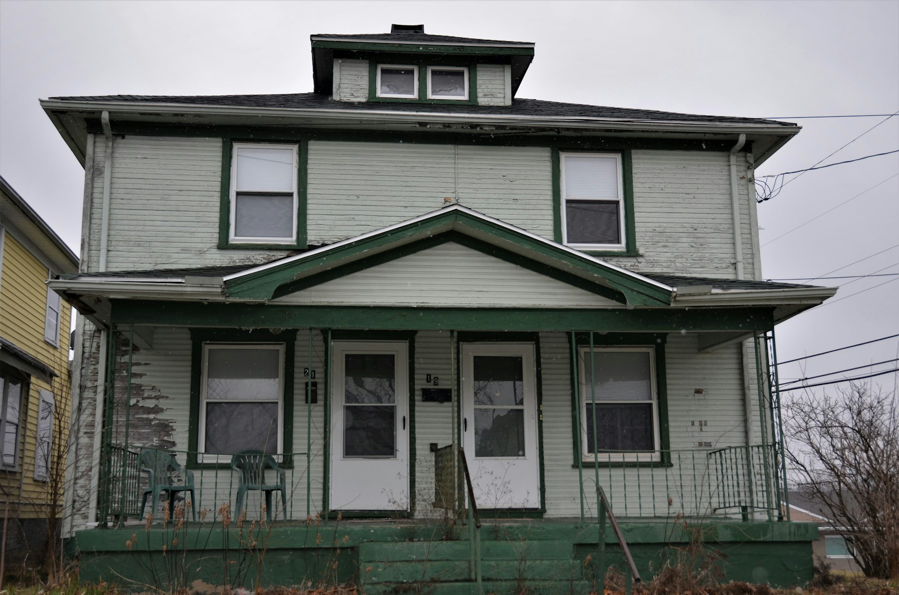 Green duplex home with two front entries